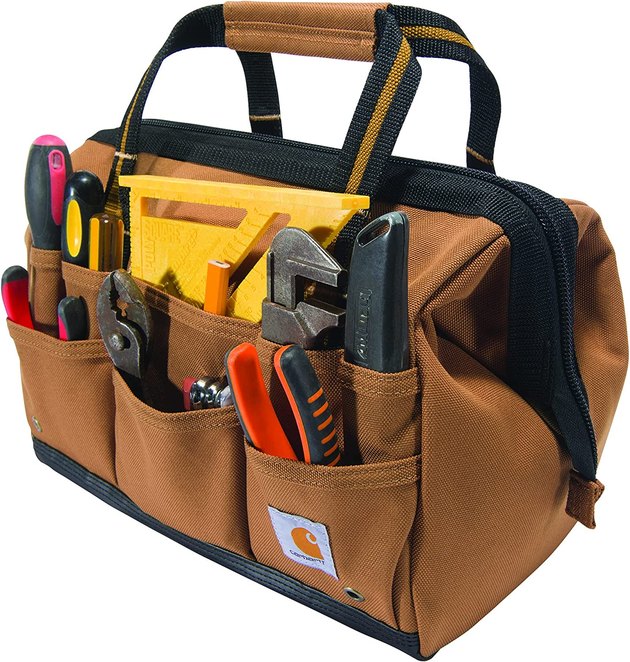 Store his tools in quality and style with this classic design from Carhartt. The internal metal frame gives the bag its structure and the fabric is ultra durable and water-repellant. 