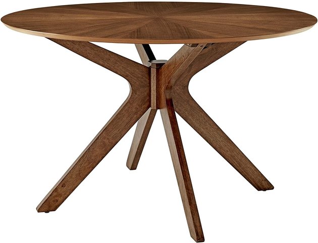 This warm walnut table with a lovely sculptural base can comfortably seat four and squeeze up to six.
