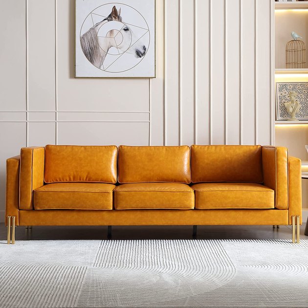 This sleek sofa is contemporary with some distinct midcentury modern inspiration. It features a solid wood frame, removable armrests, and a waterproof finish.