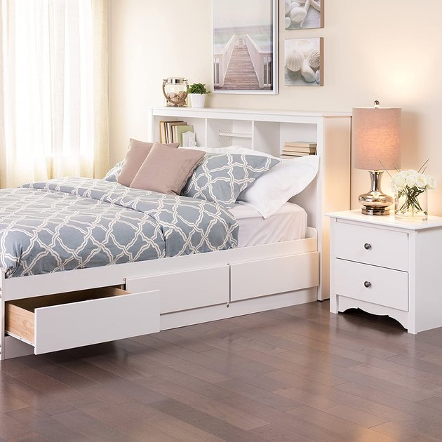 If you’re tight on space but need extra storage, try this bookcase headboard. Made with durable composite wood and a laminate finish, it has three storage compartments for all your smaller pieces of decor.