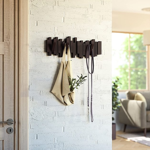 We love a space-saving solution and this wall-mounted coat rack is just that. Hang it in your entryway for storage when you need it and a piece of sculptural wall art when you don't.