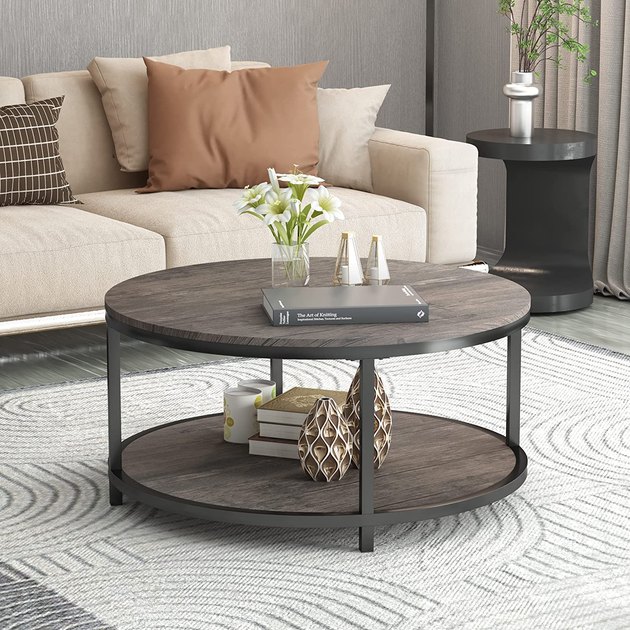 This round coffee table offers the best of all worlds. It features a blend of materials like wood and metal, a sturdy storage shelf, and a budget-conscious price tag.