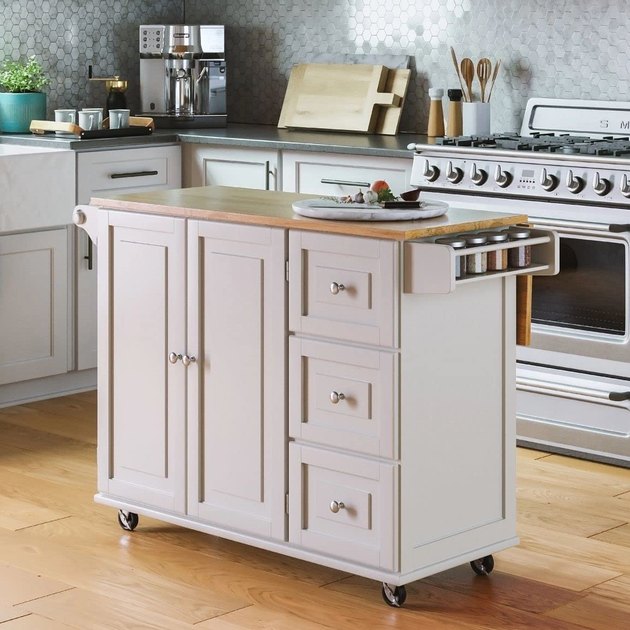 This kitchen cart looks good enough to be considered a built-in, but your visitors will never know it's on wheels. There are cabinets, shelves, and hooks to hold all of your storage needs.