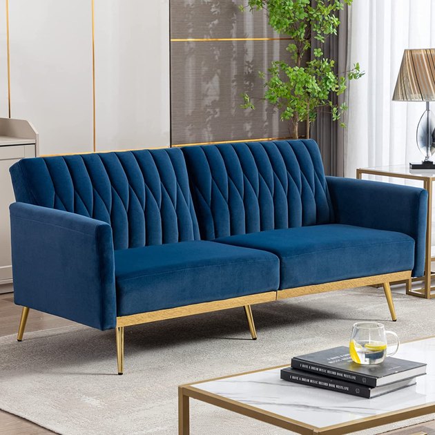 This elegant and affordable velvet sofa has a zipper-like tufting that makes it stand out. It's also multi-functional and folds down into a futon.