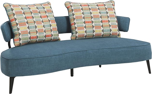 This loveseat has a playful design with patterned pillows to match. With a soft fabric upholstery and black tapered legs, it’d be a stunning addition to any space.