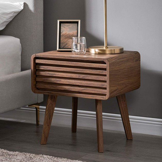 From the slatted wood to the tapered legs, this nightstand absolutely screams midcentury modern. The hidden drawer is actually quite spacious and the piece as a whole is super easy to assemble.