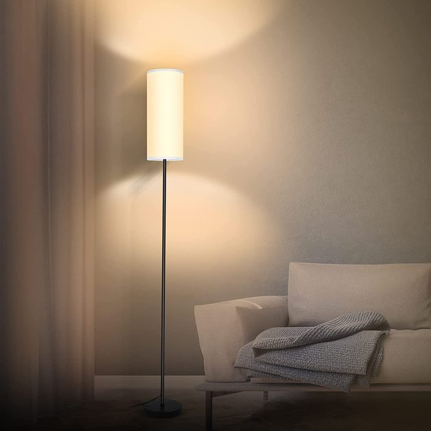 Adjust the brightness and temperature of this tall and slender floor lamp using a convenient remote control.