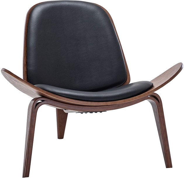 Could you get any more midcentury modern than this accent chair? With a windback design, low-profile, and faux leather accents, it’s just what your home needs.