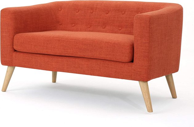 This charming loveseat clocks in at just under $300 — making it an easy pick for our favorite budget option. It’s upholstered in a bold muted orange fabric for a burst of color.