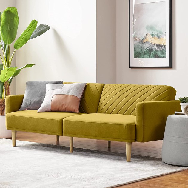 With a bright hue and geometric tufting, this velvet futon is sure to catch your eye.