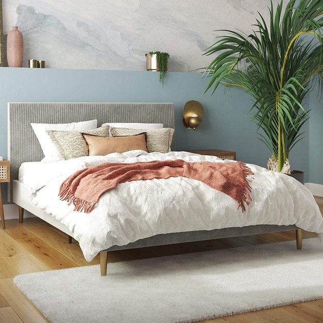This bed frame's velvet upholstered headboard is beautiful elegant in its simplicity, offering versatile style that will complement a wide variety of looks. 