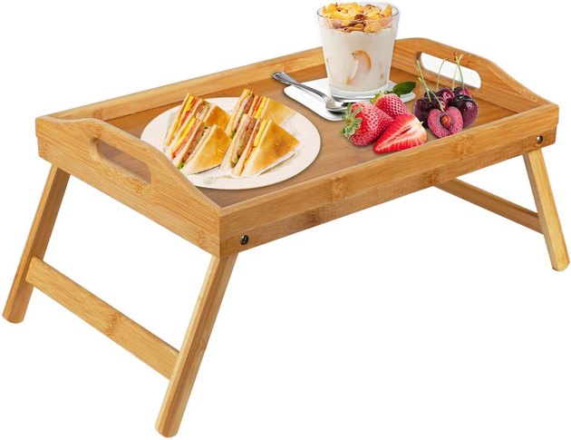 Made from sustainable bamboo, this bed tray has foldable legs that allows the tray to lay flat or be propped up. It also has handles, so you can move it around with ease.