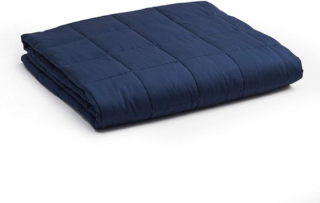 The YnM Weighted Blanket comes in an assortment of colors and weights of 5 pounds to 30 pounds. It has a unique seven-layer design made from breathable materials for temperature control. Additionally, the blanket's premium glass beads contour to your body for maximum comfort.