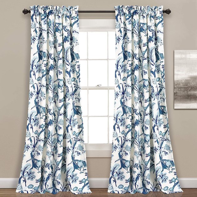 Flora and fauna meet in these Chinoiserie-style curtains. The blue and white color palette is perfect for a coastal grandmother-inspired home.