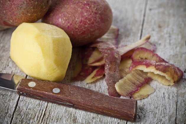 healthy organic peeled potatoes and knife