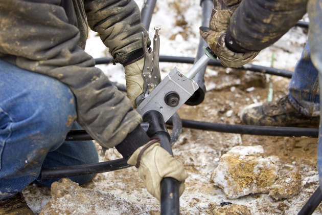 Two Workers Join Residential Geothermal Heating/Cooling Pipe