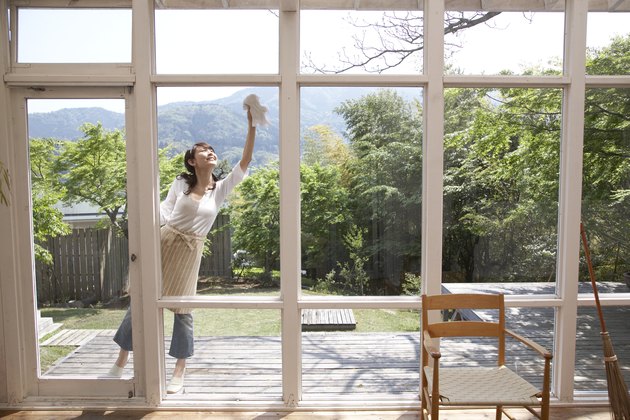 Woman on patio cleaning windows