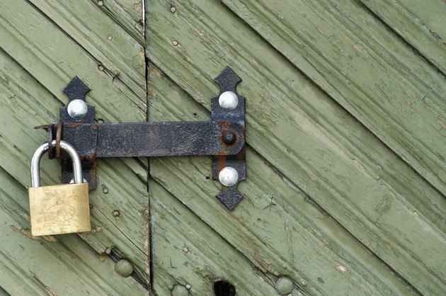Close-up of a wooden door with a padlock