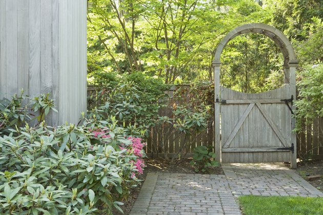 Yard with brick walkway and wooden gate