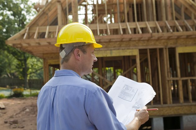 Contractor reading blueprint