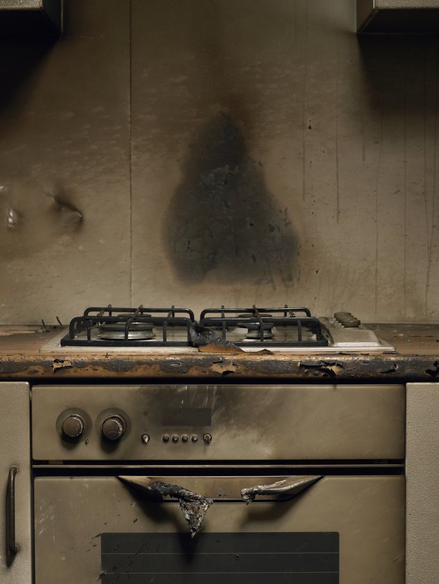 Smoke stained cooker in kitchen after fire