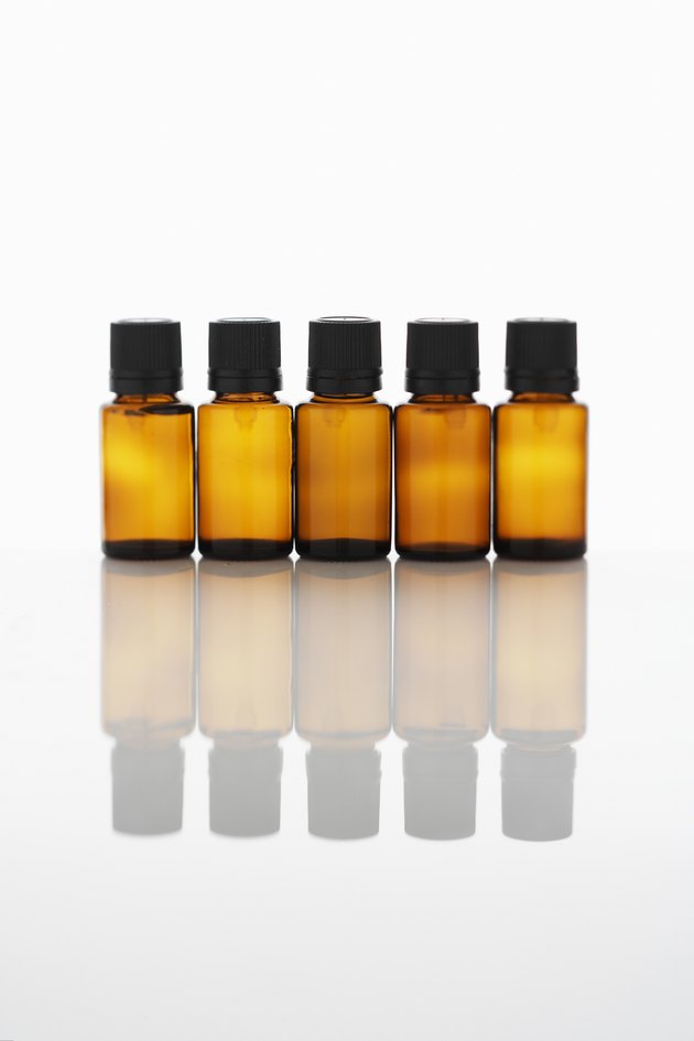 Five bottles of aromatherapy oil side by side