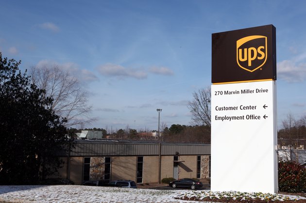 UPS Raises Outlook But Plans To Cut 1,800 Jobs