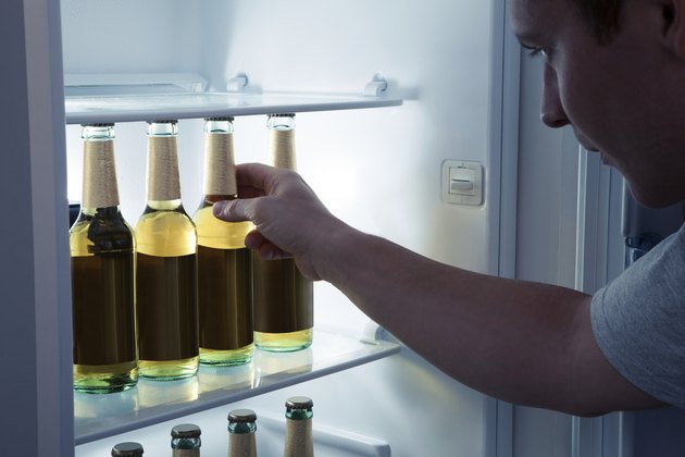 Man taking beer from a fridge