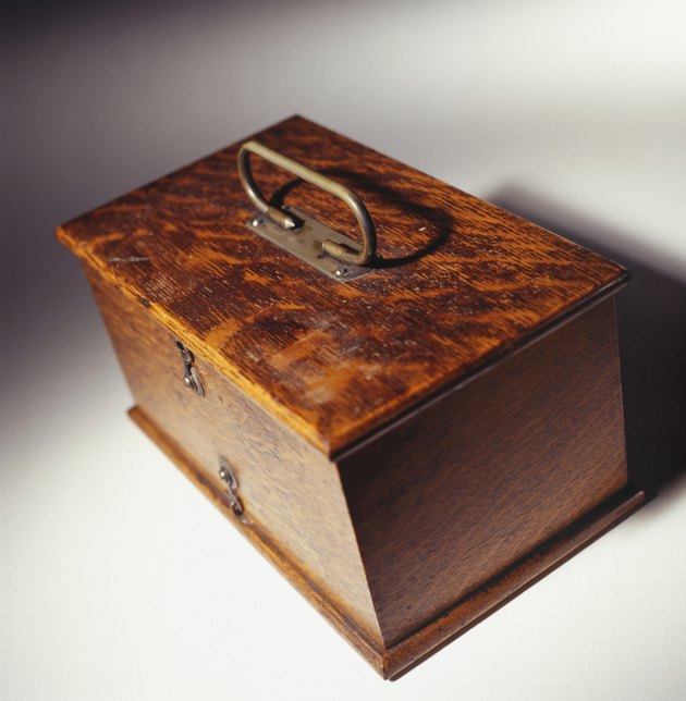 Polished antique wooden oak box with brass handle