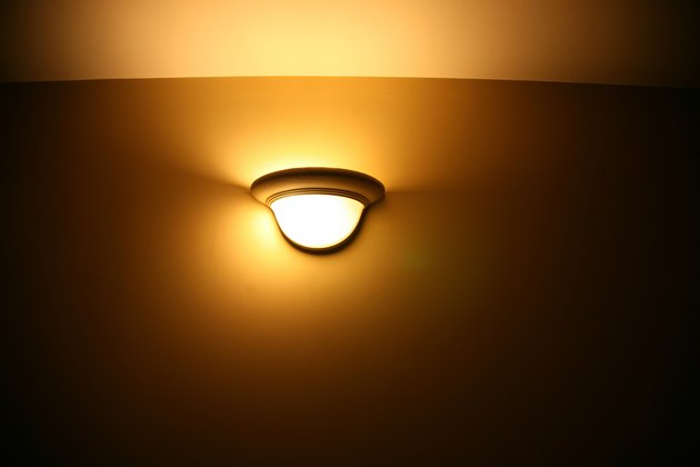 Glowing light fixture on wall