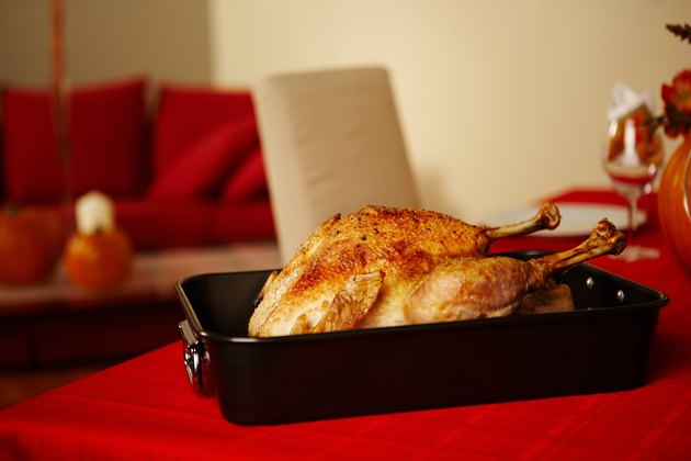 Roasted turkey in pan on dining room table