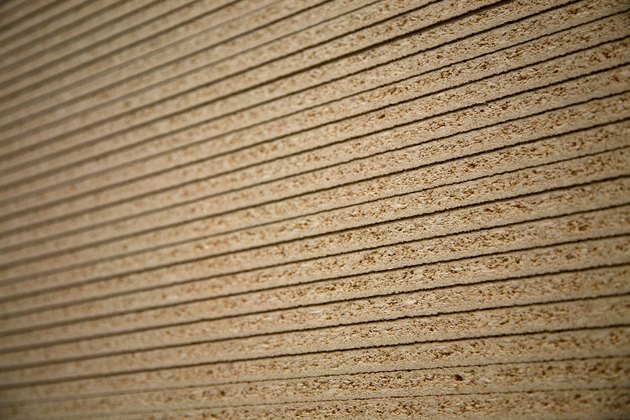 Sheets of particleboard stacked neatly