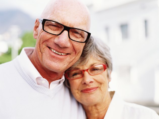 Senior couple wearing spectacles, smiling, portrait