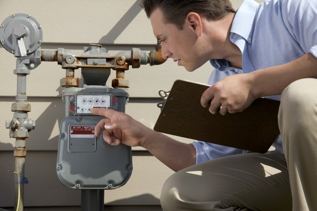 Man with clipboard checking meter