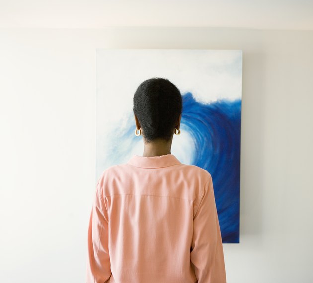 African woman looking at painting