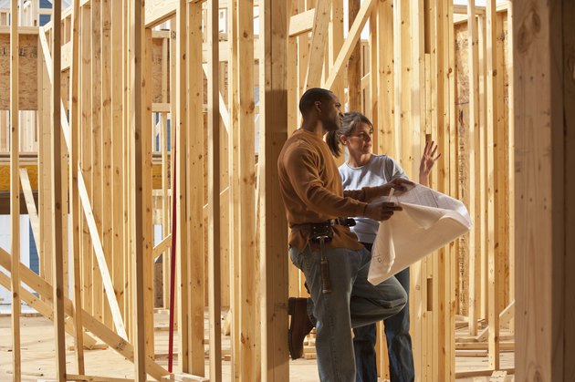 Carpenter showing woman house plans