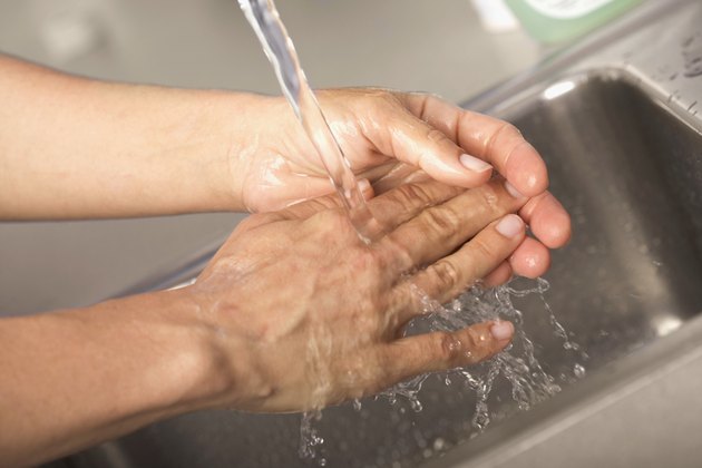 Healthcare worker washing hands in hospital