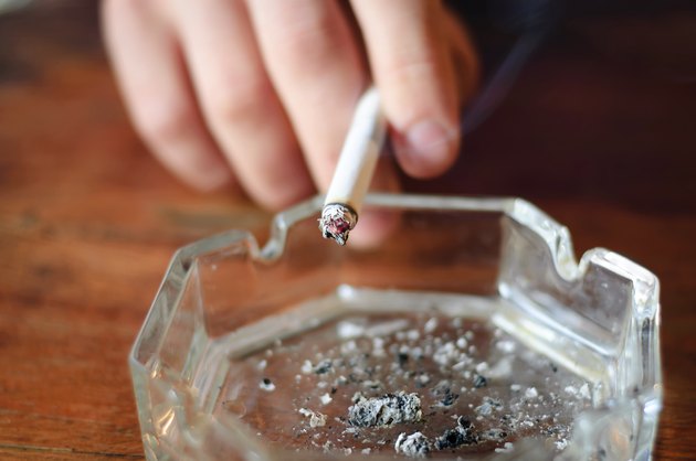 hand with cigarette and ashtray