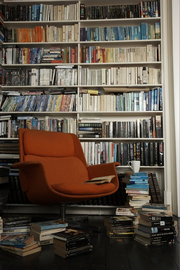 comfortable chair surrounded by books