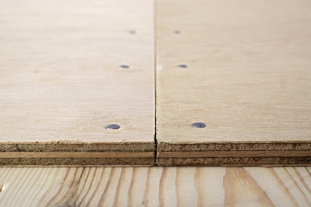 Butt joint on plywood nailed to wooden floor, close-up