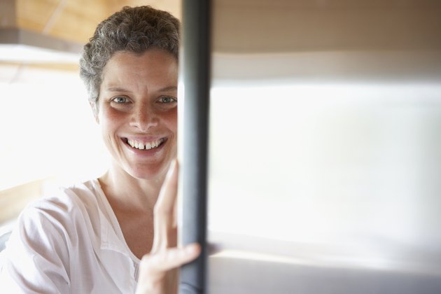 Mixed Race woman looking in refrigerator