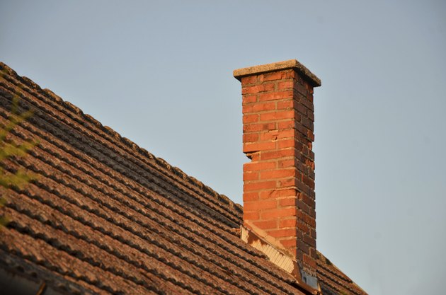 Orange roof tiles, brick chimney and blue sky