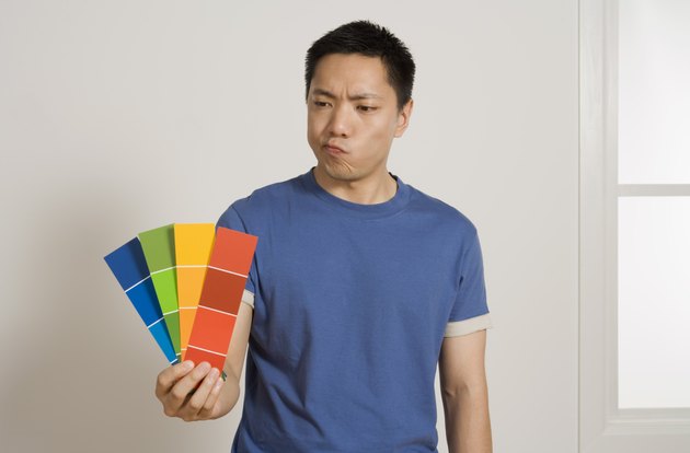 Man holding paint samples