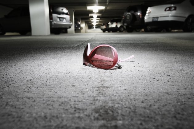 Sunglasses on concrete in parking garage (focus on sunglasses)
