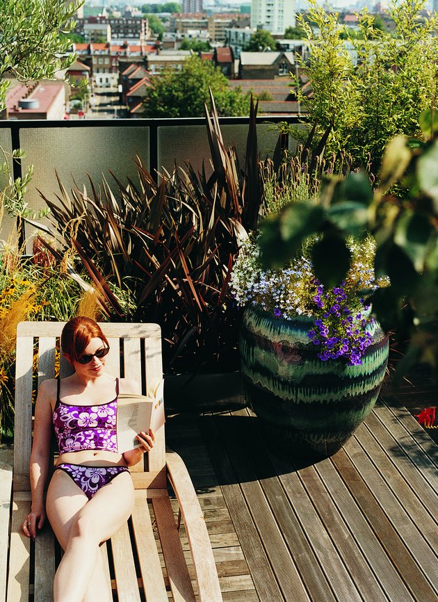 Woman Sunbathing in Her Roof Garden
