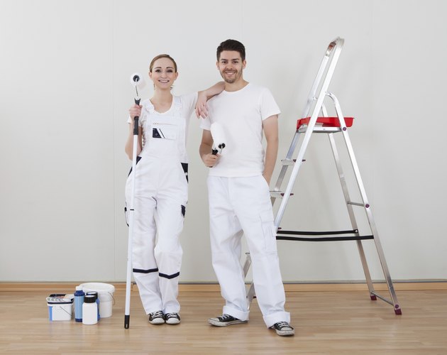 Young Couple Holding Paint Roller