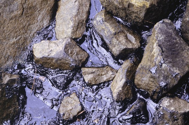 River bank with oil spill in water