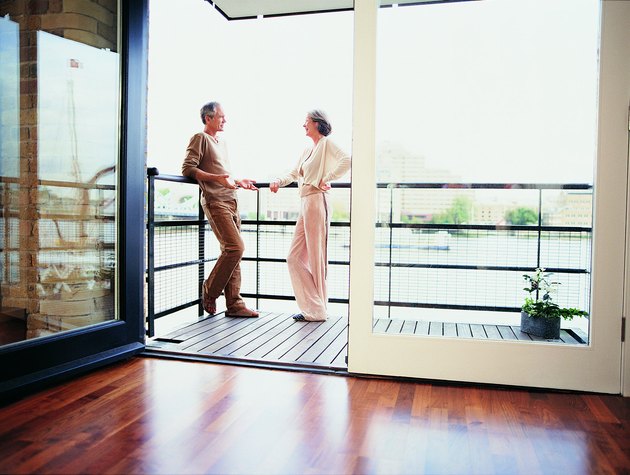 Mature Couple Talking on the Balcony of Their Apartment