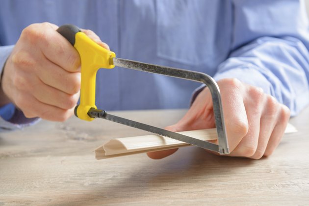 Cutting plastic molding with handsaw