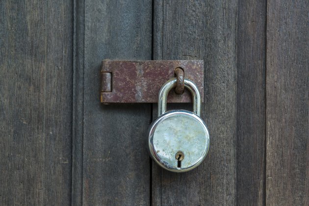 Old padlock on a wooden door